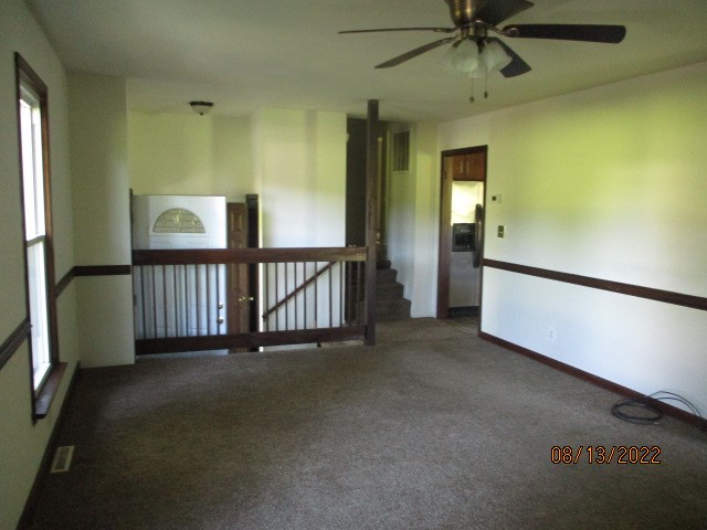 Living room viewed toward front door and kitchen